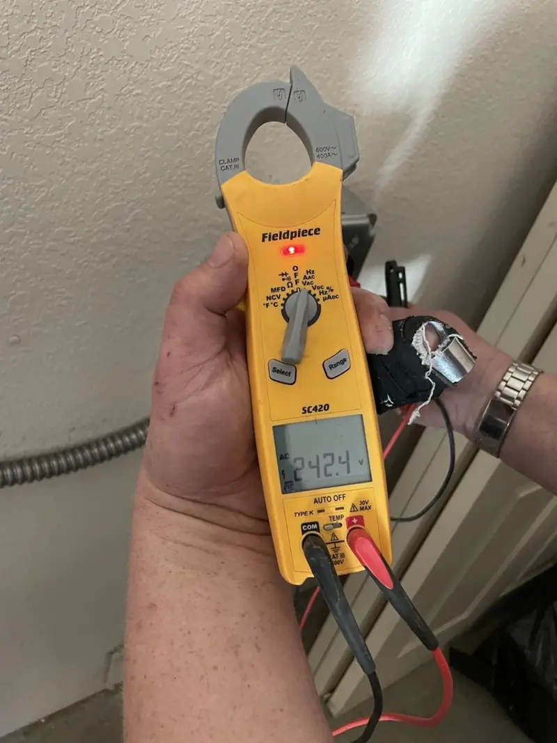 Voltage testing with clamp meter during Outlet Installation in Durham